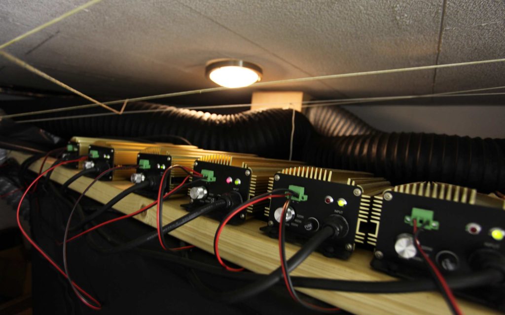 These ballasts sit atop a grow tent; notice the wood shelf used to keep the heat off the tent material.