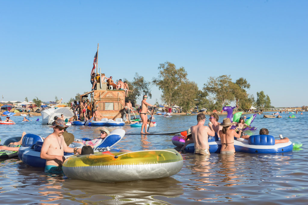 Revelers lounge in floaties all day and party all night at Symbiosis Gathering! (Photo by Jorgenson Photography)