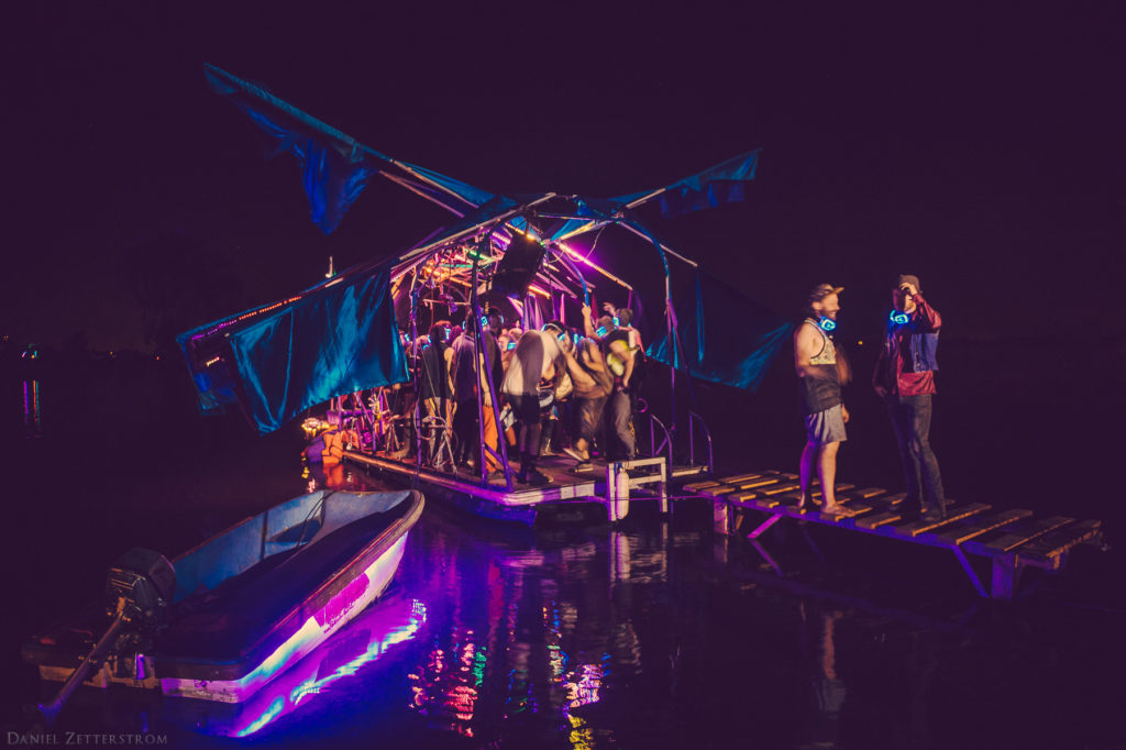 Symbiosis glows at night, including this beautifully lit dance barge. (Photo by David Zetterstrom)